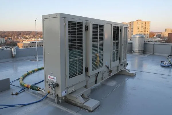 Direct-fired restaurant makeup air unit mounted on a flat commercial roof in Toronto with gas supply line