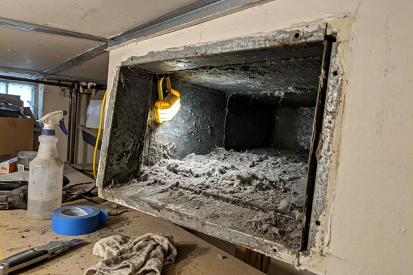 Dusty return air duct in a Scarborough bungalow with debris buildup before cleaning