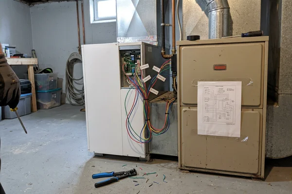 Air handler paired with a gas furnace for a dual-fuel heat pump setup in a Toronto basement