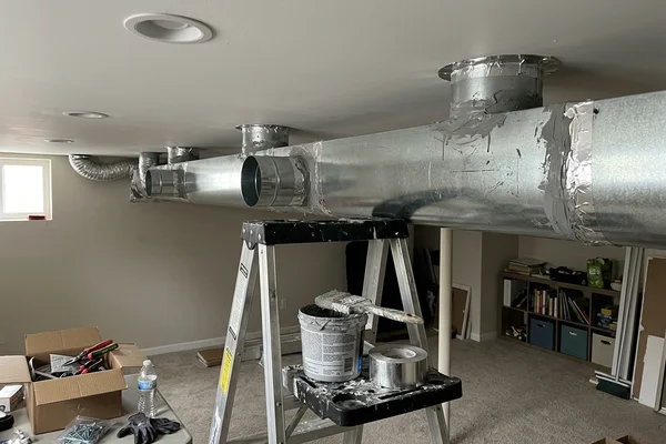 New sheet metal trunk duct with sealed joints in a finished basement ceiling in a Toronto semi
