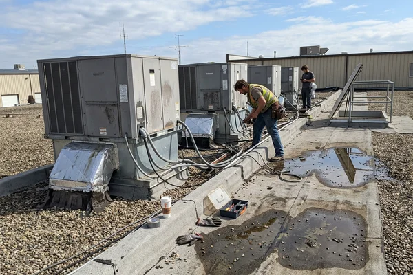 Row of packaged rooftop units on a flat roof of a GTA retail plaza