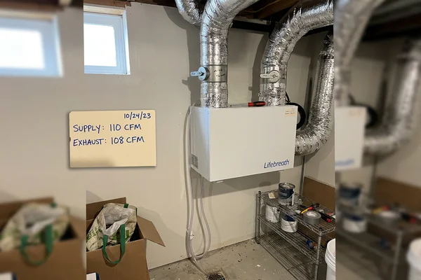 Wall-mounted heat recovery ventilator with insulated ducting and balanced dampers in a Markham new-build home